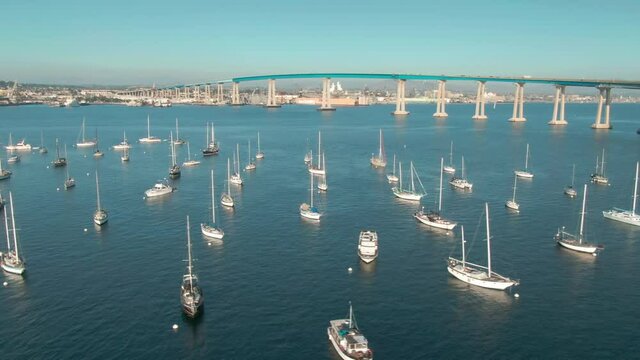 Aerial: yachts docked in the San Diego Bay and the Coronado Bridge, California, USA