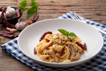 Stir-Fried Capellini pasta With Dried Chili And Sliced chicken on white plate