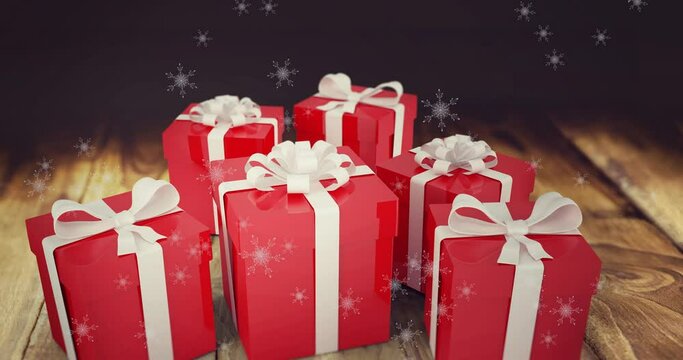 Animation of snow falling over presents on wooden background