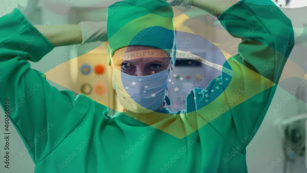 Wall mural Animation of flag of brazil waving over surgeon in face masks