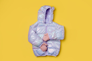Kids warm puffer jacket with hood  on pink background. Stylish childrens outerwear. Winter fashion...