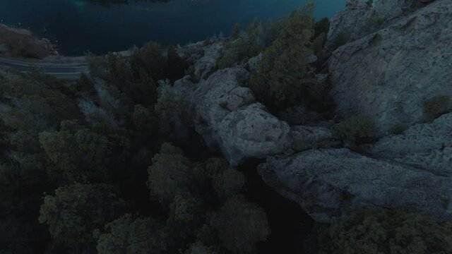 Dive into rocks formation in a valley with a river Aerial FPV Footage