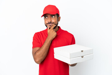 pizza delivery man picking up pizza boxes isolated on white background having doubts and thinking
