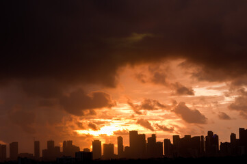front view, very far distance of a silhouetted skyline of Miami, Florida at dawn, sunrise