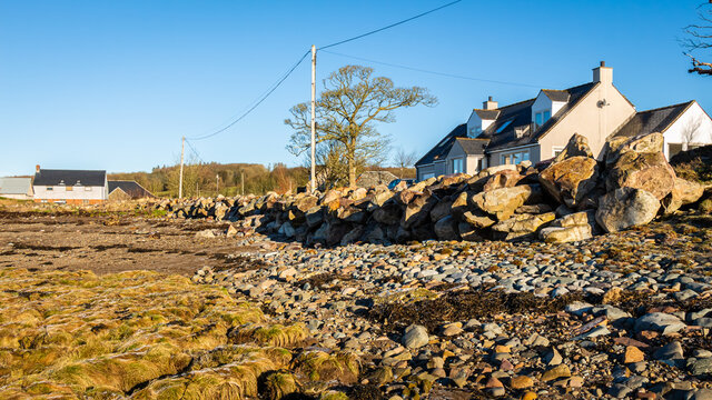 Riprap rock acting as a coastal sea defence from erosion on a cobble beach