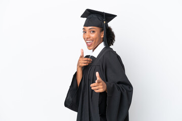 Young university graduate African American woman isolated on white background pointing to the front and smiling