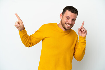 Young Brazilian man isolated on white background pointing finger to the laterals and happy