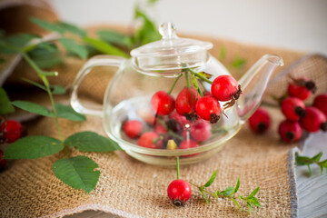 ripe red rose hips on a wooden table