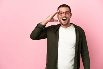 Young Brazilian man isolated on pink background has realized something and intending the solution