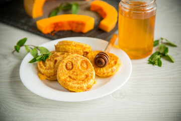 sweet lush pumpkin pancakes with honey in a plate