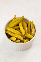 Green chilli pepper pickled on a white background