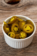 pickled sliced green jalapeno peppers in white bowl