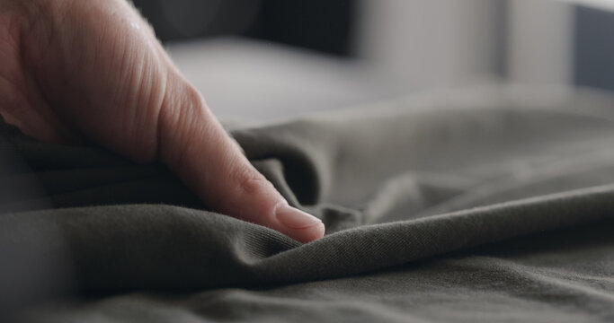 Man Touching Green Cotton Clothes Closeup