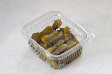 Packed crunchy pickled cornichons. Pickled cucumber. Delicious baby pickles.