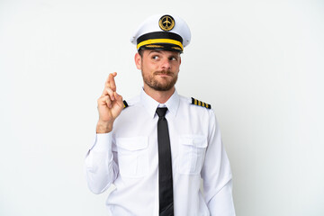 Airplane Brazilian pilot isolated on white background with fingers crossing and wishing the best