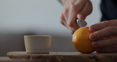 man cut sweet lemon on olive board