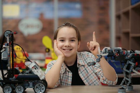 Boy Works on a Fully Functional Programable Robot for His School Robotics Club Project.