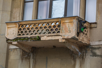 Old stone balcony with traffic lights. Part of an old industrial building