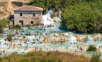 The gorgeous natural thermal bath of Saturnia. Warm water spills out of the rock creating a...
