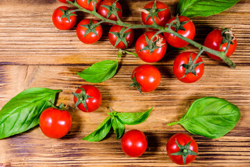 Heap of small cherry tomatoes on wooden table. Top view