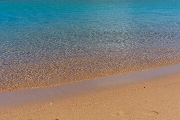 Closeup of the sand on beach and Red sea water