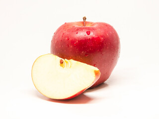 fresh wet red apple with slice on a white