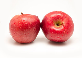 pair of apples with water drops isolated on white