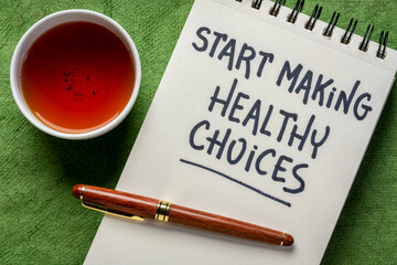 start making healthy choices motivational reminder - handwriting in a spiral notebook with tea,...