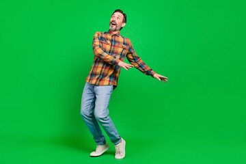 Fototapeta premium Full length body size view of attractive dreamy cheerful funky man having fun isolated over bright green color background