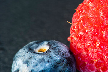 Macro Fruit: Ripe raspberry extreme close-up, black background, horizontal format