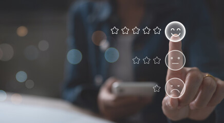 Woman user pressing smile face emoticon on virtual touch screen. Customer service evaluation concept