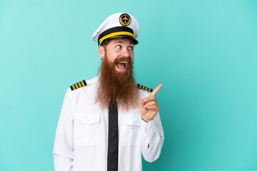 Redhead caucasian man playing rugby isolated on yellow background intending to realizes the solution while lifting a finger up