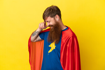 Redhead Super Hero man isolated on yellow background laughing