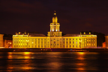 City night landscape with a view of the 'Kunstkamera' building in St. Petersburg and the reflection...