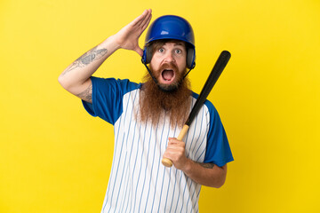 Redhead baseball player man with helmet and bat isolated on yellow background with surprise expression