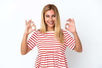 Blonde Uruguayan girl isolated on white background showing ok sign with two hands