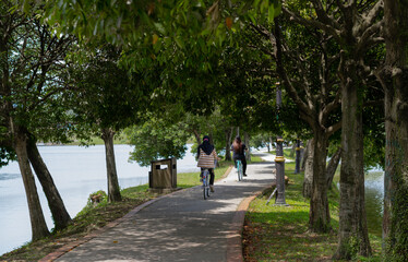 Obraz premium City park famous place for cycling outdoor. People riding bicycle in the lane in the park during weekend. 