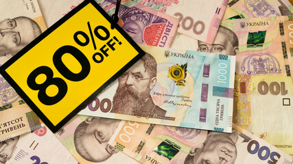 Yellow sale label on money hryvnia background. Black friday sale. Ukrainian money