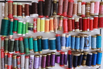 Rows of colorful sewing thread spools