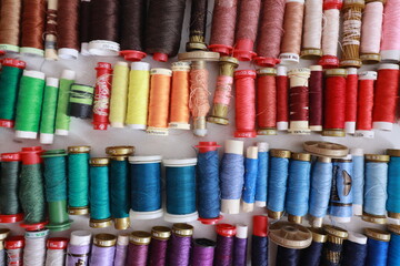 Rows of colorful sewing thread spools