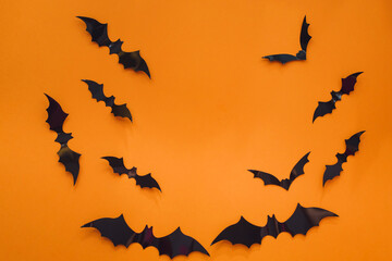 Halloween background. Bats on an orange background. Flat lay, copy space
