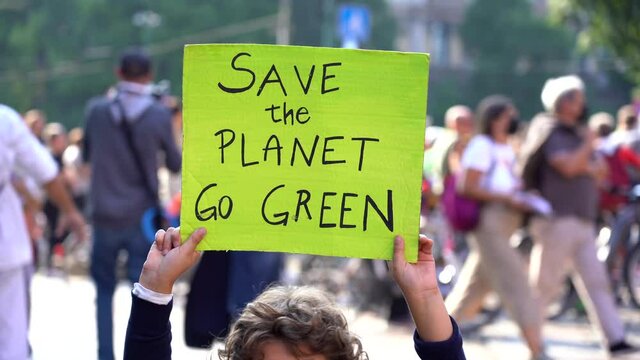 Italia, Milano , Activist boy Child 7 years old with sign Save the Planet , go green - Friday for Future Youth 4 Climate - student demonstration against climate change and global warming 