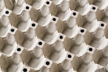 Empty egg tray texture. Background of large cardboard container for chicken eggs. Biodegradable...