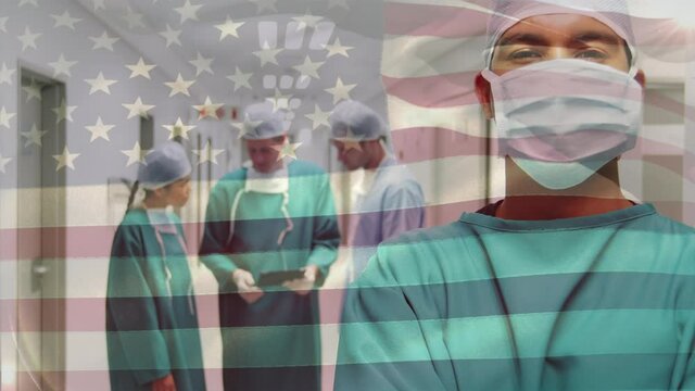 Animation of flag of usa waving over surgeons in operating theatre
