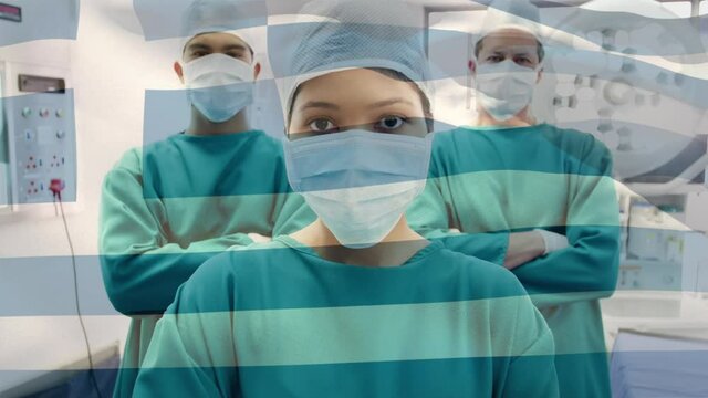 Animation of flag of greece waving over surgeons in operating theatre