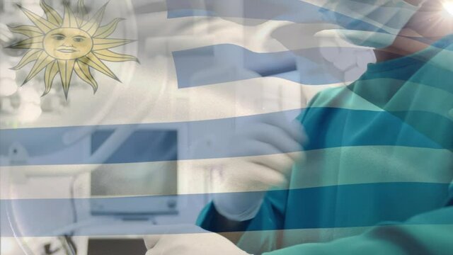 Animation of flag of uruguay waving over surgeon in operating theatre
