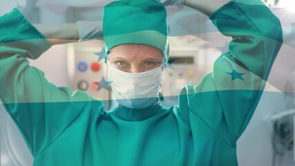 Animation of flag of honduras waving over female surgeon in operating theatre - Powered by Adobe