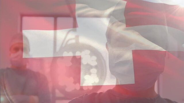 Animation of flag of switzerland waving over surgeons in operating theatre