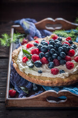 Sweet and homemade pie with berries and cream