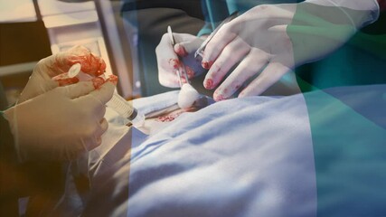 Animation of flag of nigeria waving over surgeons in operating theatre - Powered by Adobe